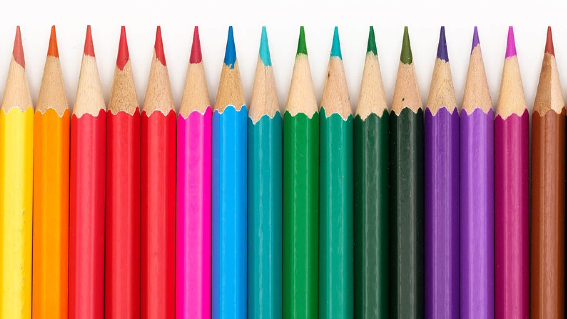 Colored pencils lined up to resemble a rainbow