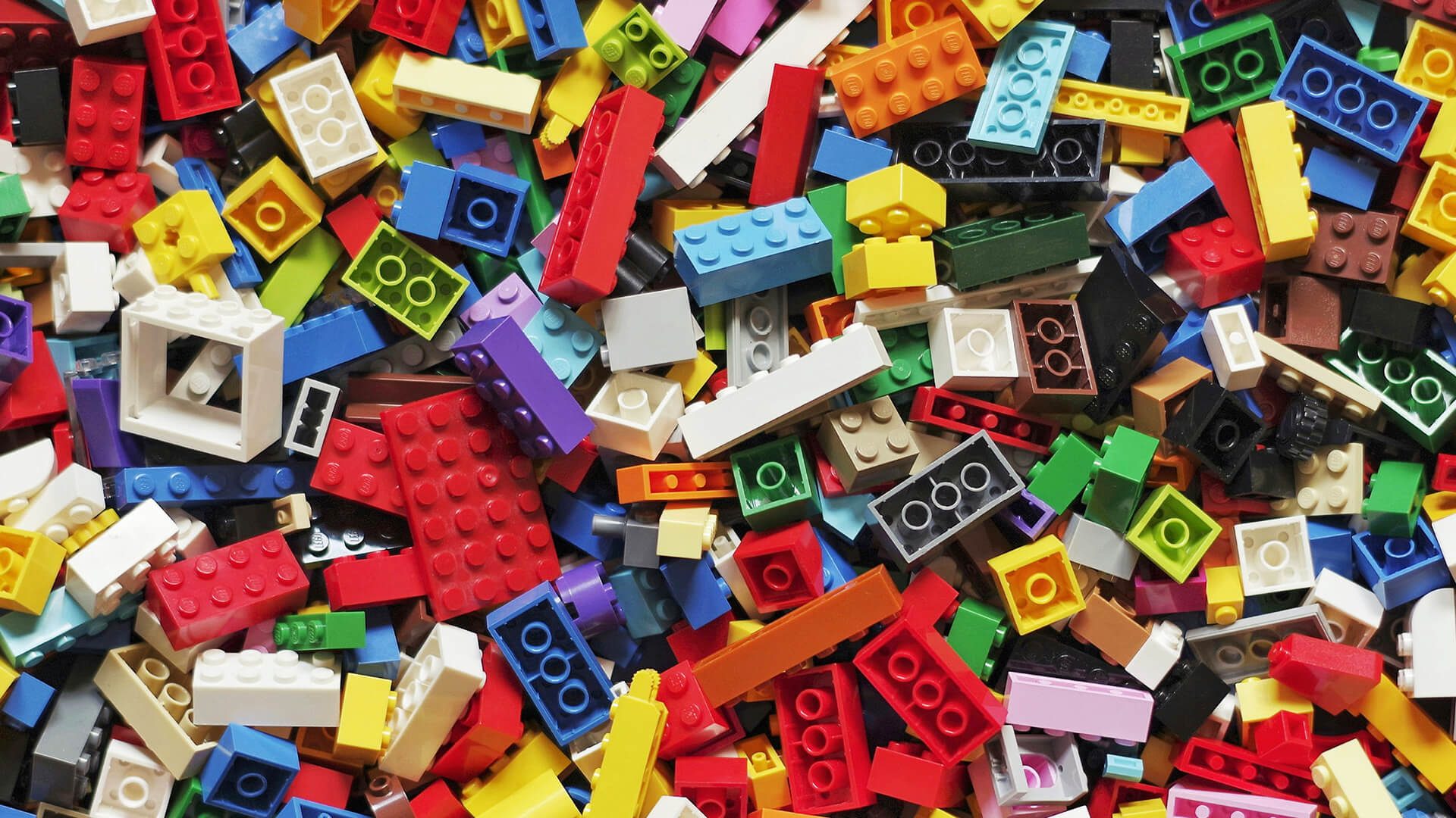 A large pile of colorful LEGO bricks of various sizes and shapes.