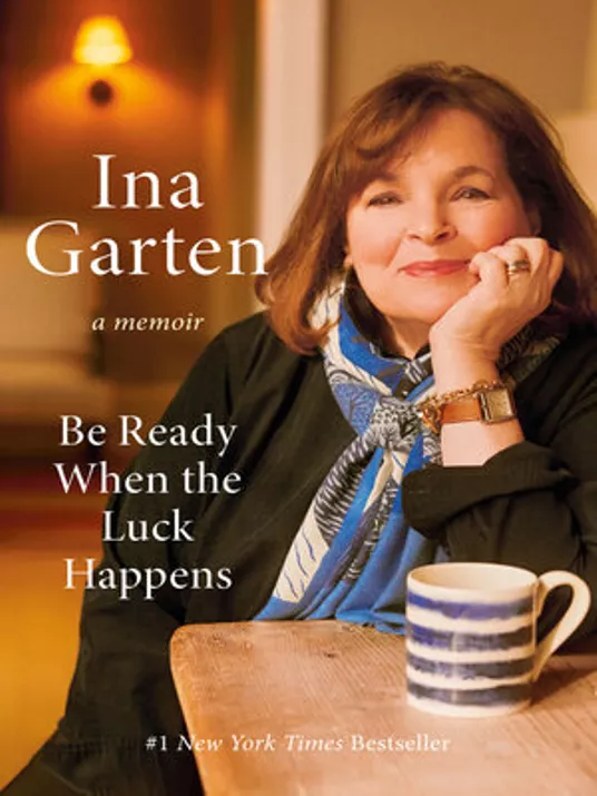 Portrait of the author with a cup of coffee at a table on the cover of "Be Ready When The Luck Happens" by Ina Garten